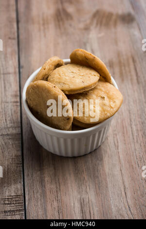 spicy fried mathri or mathari which is an indian snack served with a ...