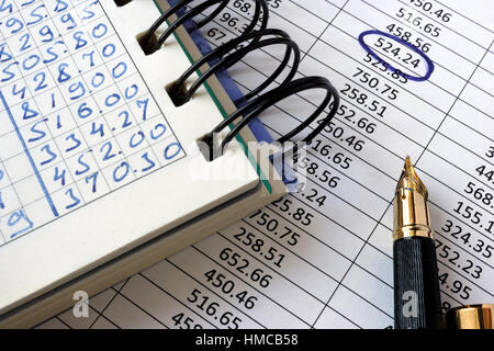 Note with financial data and pen. Accounting concept. Stock Photo