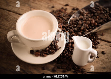 cappuccino cup and coffee beans - tilt shift effect photo Stock Photo