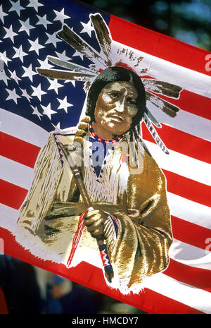 Native American powwow souvenir - American flag with the image of a Native American man in traditional costume printed on it. Stock Photo