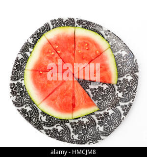 Watermelon slices on a plate, one slice missing Stock Photo