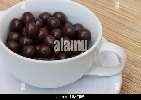 Chocolate covered espresso coffee beans in a cup Stock Photo