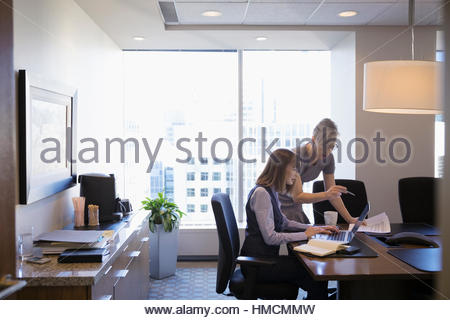 Female lawyers meeting working at laptop in conference room