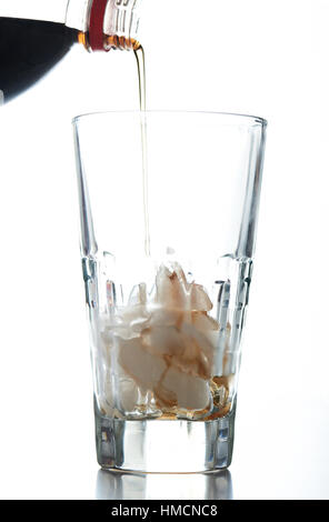 pouring soda in to glass with ice isolated on white Stock Photo