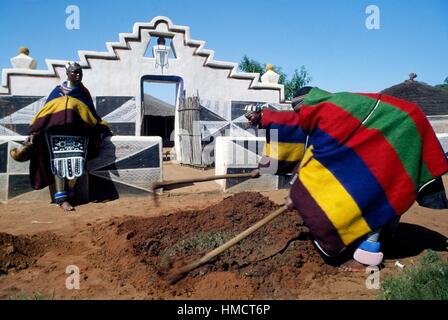 Men mixing clay in a Ndebele village, South Africa. Stock Photo