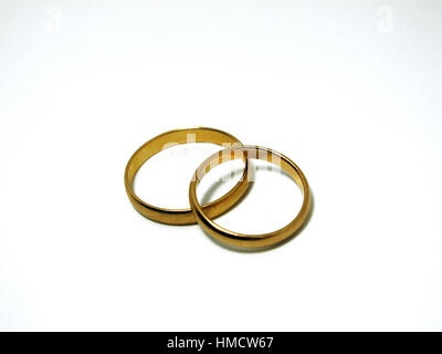 Couple of gold wedding rings on white background isolated Stock Photo