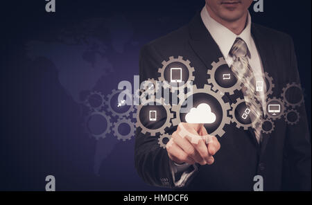 Businessman holding a cloud connected to many objects on virtual screen concept about the internet of things Stock Photo