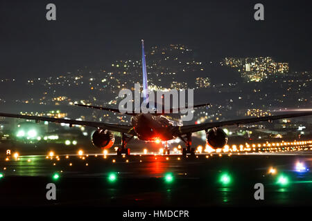 Airplane taking off from the airport in the night. Stock Photo