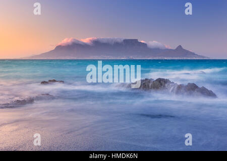 Sunrise over the Table Mountain and Cape Town from the beach of Bloubergstrand.