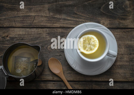 Tea cup with lemon on wooden table from above Stock Photo