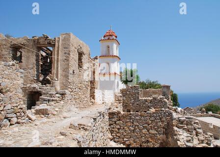 The church of Agia Zoni stands among the ruins of the abandoned village of Mikro Chorio on the Greek island of Tilos. Stock Photo