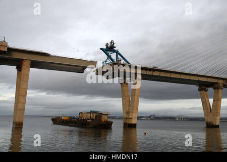 The final deck piece of the Queensferry Crossing over the Firth of Forth, sits on a barge ahead of it being lifted into position. Once the operation to start the lift begins, it will take around four hours to complete. Stock Photo