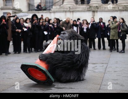 A performer in an animatronic gorilla suit in Trafalgar Square, London, interacts with members of the public during a promotion by the Uganda Tourism Board to highlight Uganda as a holiday destination. Stock Photo