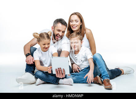 Smiling family using digital tablet Stock Photo