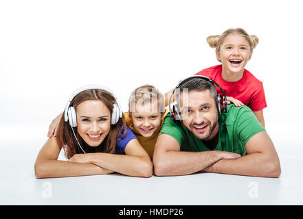 Parents in headphones with kids Stock Photo