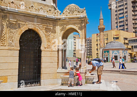 Izmir, Izmir Province, Turkey.  Konak Square. The Yali or Konak Mosque seen from the Clock Tower which is partly seen on the left. Stock Photo
