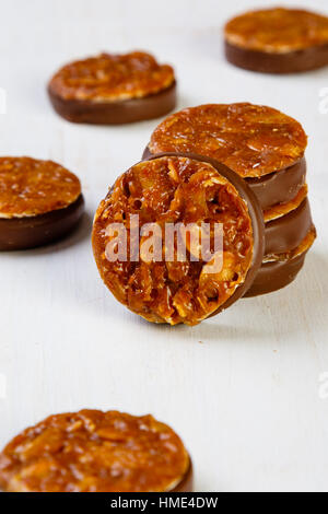 Assortment of delicious chocolate pralines on white table Stock Photo