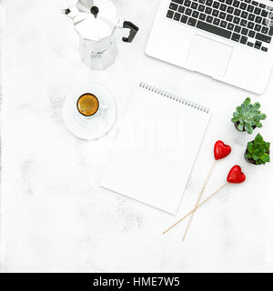 Laptop, coffee, open book and red hearts. Home office workplace. Flat lay for social media blog Stock Photo