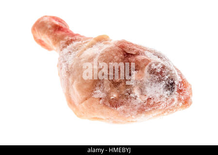 Frozen raw chicken leg meat isolated on white. Frozen uncooked piece of poultry drum stick with ice crystals on it. Stock Photo