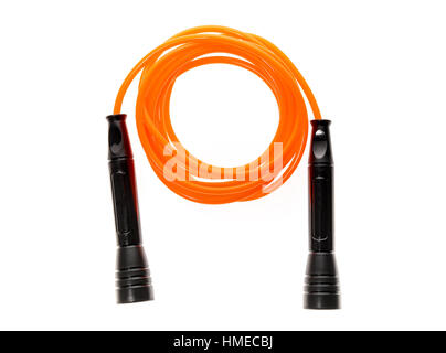 Orange jump rope or skipping rope isolated on white background. Sports, fitness, cardio, martial art and boxing accessories. Stock Photo