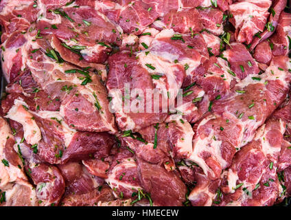 Raw pork neck chops meat with spices ready for barbecue. BBQ uncooked fresh slices of beef steaks - tenderloin or rib eye. Meat background texture pat Stock Photo
