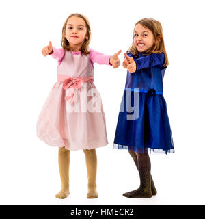 Children posing in studio, fooling around making different facial expressions, making thumbs up gesture. Concept of encouragement, acceptance and bein Stock Photo