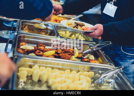 Cuisine Culinary Buffet Dinner Catering Dining Food Celebration Party Concept. Group of people in all you can eat catering buffet food indoor in luxur Stock Photo