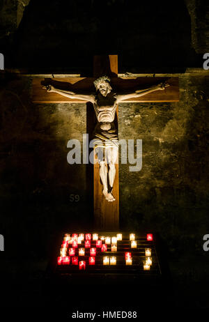 Jesus Christ on the cross lit by candles, Chartres Cathedral in France Stock Photo