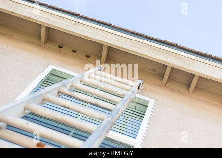 Aluminum Construction Ladder Leaning Against House. Stock Photo