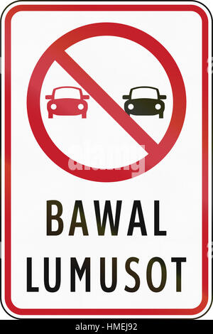 Road sign in the Philippines with Filipino words - Overtaking Prohibited. Stock Photo