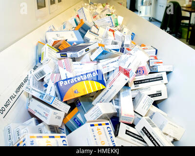 packets of medication wait in the hospital pharmacy and the automated dispensary machine Stock Photo