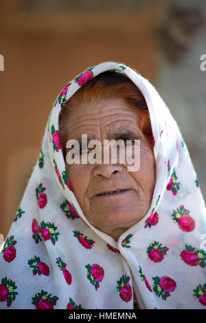 Portrait of a mature woman with hair colored with henna and traditional headscarf, Abyanhe Village, Iran Stock Photo