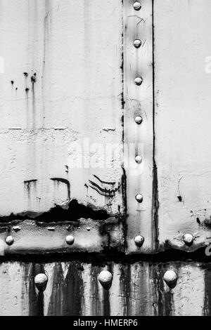 White industrial metal wall with rivets pattern, front view, background ...
