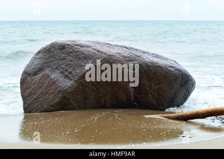 a huge stone boulder on the shore of the sea Stock Photo