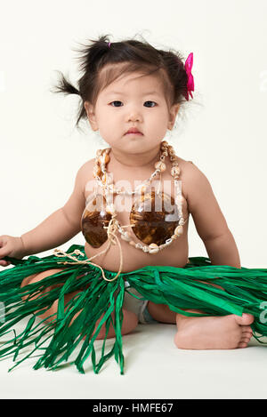 Cute Asian Chinese baby girl dressed in Hawaiian outfit. Stock Photo