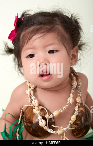 Cute Asian Chinese baby girl dressed in Hawaiian outfit. Stock Photo