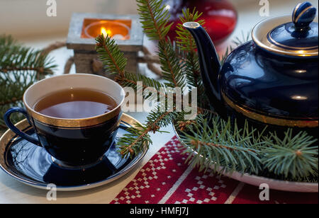Set of decorative porcelain cup, plates, teapot with blue and gold pattern in the xmas style with tea. Food photo, Christmas concept Stock Photo