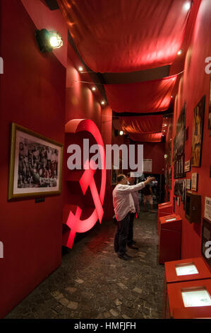 A display of photographs and the Russian hammer & sickle at the Warsaw Uprising Museum in Grzybowska, Warsaw,Poland Stock Photo