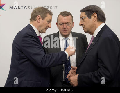 Taoiseach Enda Kenny (left) speaks with Danish Prime Minister Lars Lokke Rasmussen (centre) and Cypriot President Nicos Anastasiades at the Grandmaster's Palace in Valletta, Malta, during an informal summit. Stock Photo