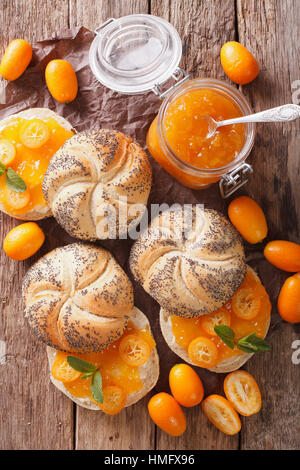 Sweet buns with kumquat jam and cream cheese close-up on the table. vertical view from above Stock Photo