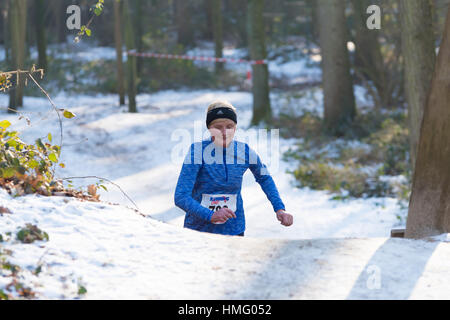 OLDENZAAL, NETHERLANDS - JANUARY 22, 2017: Unknown female athlete doing a cross run in a forest Stock Photo