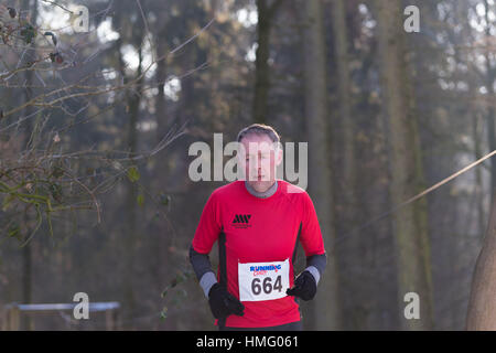 OLDENZAAL, NETHERLANDS - JANUARY 22, 2017: Unknown runner doing a cross run in a forest Stock Photo