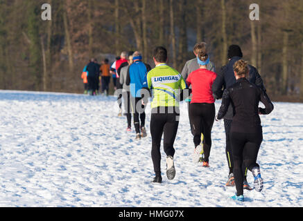 OLDENZAAL, NETHERLANDS - JANUARY 22, 2017: Unknown athletics doing a cross run in a snow white landscape Stock Photo