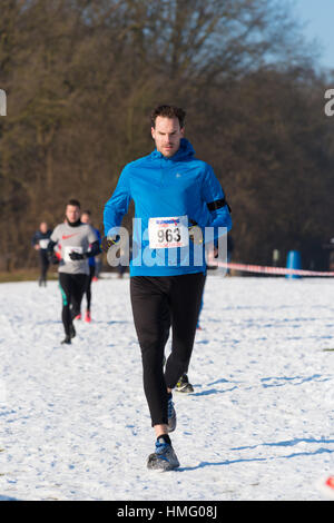 OLDENZAAL, NETHERLANDS - JANUARY 22, 2017: Unknown athletics doing a cross run in a snow white landscape Stock Photo