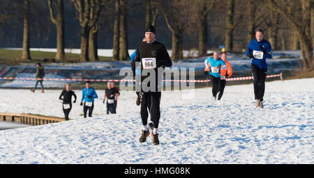 OLDENZAAL, NETHERLANDS - JANUARY 22, 2017: Unknown athletics doing a cross run in a snow white landscape Stock Photo