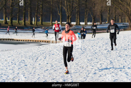 OLDENZAAL, NETHERLANDS - JANUARY 22, 2017: Unknown athletics doing a cross run in a snow white landscape Stock Photo