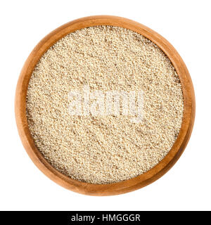 White poppy seeds in wooden bowl. Oilseed from opium poppy Paper somniferum with tiny kidney shaped seeds. Stock Photo