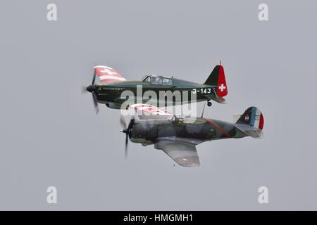 Morane D-3801 flying next to a Curtiss Hawk 75 at the Flying Legends Air Show Stock Photo