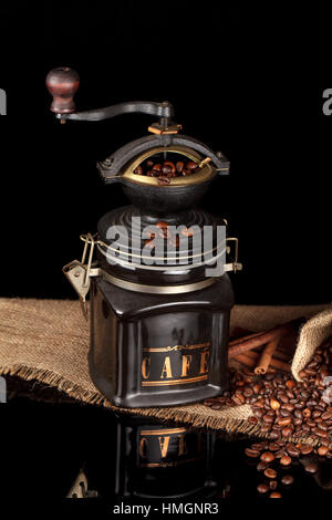 Beans, manual mill on sacking glossy table Stock Photo