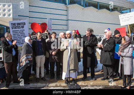 Bloomfield Hills, USA. 3rd February, 2017. Interfaith religious leaders rally during Friday prayers at the Muslim Unity Center in solidarity with the Muslim community and against the Trump administration's immigration/refugee ban. Imam Mohammad Al-Masmari is speaking. At left is a Syrian refugee family which has been separated by the ban. Credit: Jim West/Alamy Live News Stock Photo